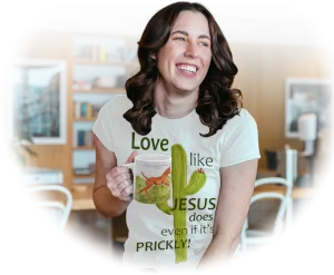 Happy woman drinking coffee from the Beautiful Colt Coffee Mug and wearing the Love Like Jesus Even if it's Prickly Haloed Tee by AFH