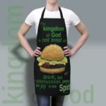 New Kingdom of God Apron: Joy in the Spirit being show worn by a woman to show the fit and finish of this exceptional quality and stylish product. Perfect for your next grill out or daily use around the kitchen.