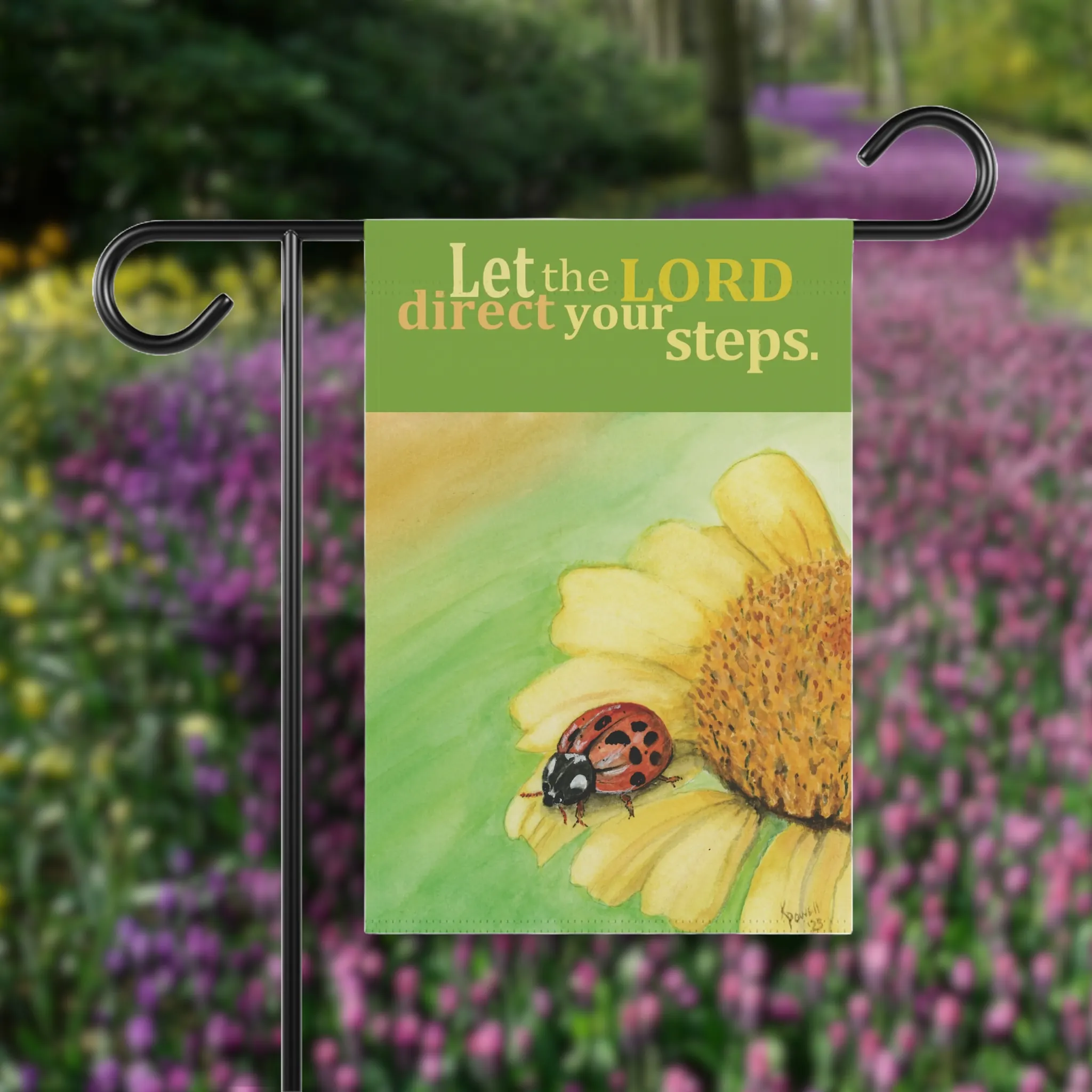 Divine Guidance, Lord's Guidance Garden Flag shown before a path of flowers. A play on imagery because the Garden flag says "Let the LORD direct your steps."