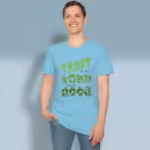Planting Trust Tee Rich New Growth in Goodness Sky Colored Haloed Tee Text Art Happy male customer wearing the Tee Shirt