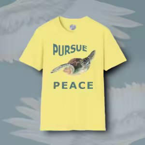 Pursue Peace Tee Beautiful Sea Turtle in Hypnotic Motion Corn Silk Colored Haloed Tee Framed By Angels Fly Here