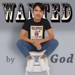 Wanted By God Your Love and Trust Black Haloed Tee Happy sitting Male Customer wearing the WANTED Tee Shirt